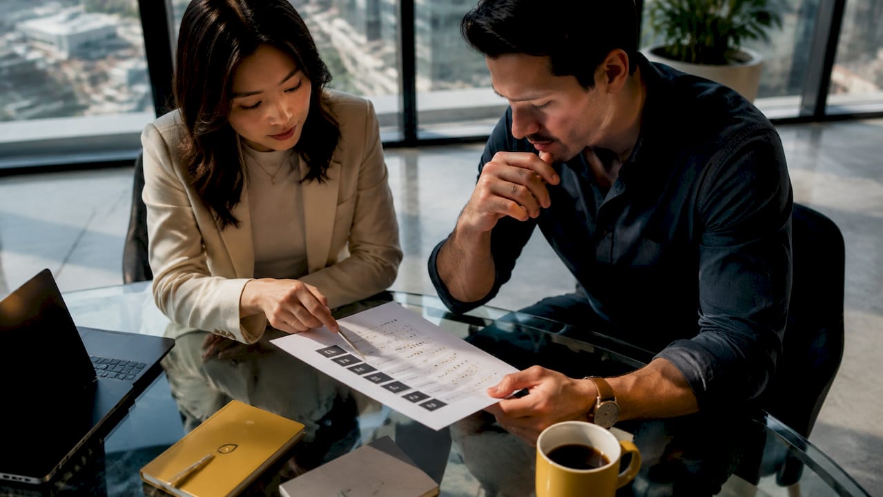 Two professionals discussing marketing agency rankings