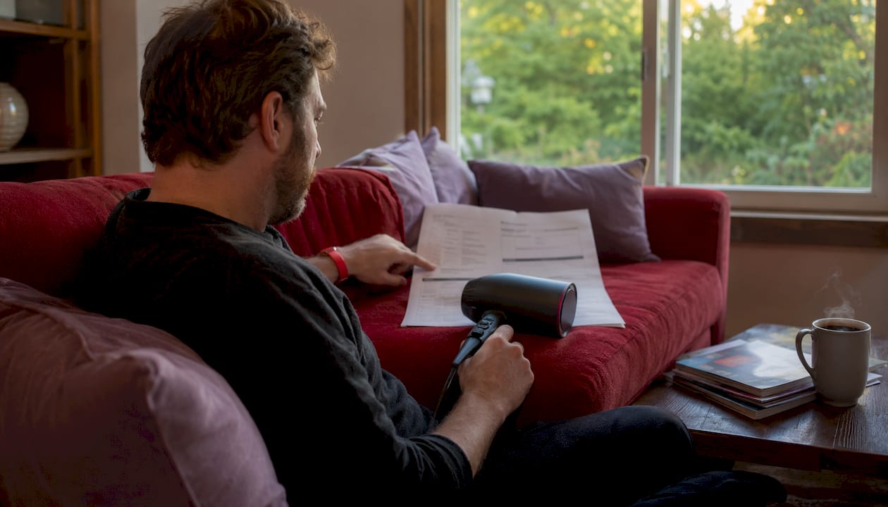 Overhead view of electricity bill with hair dryer