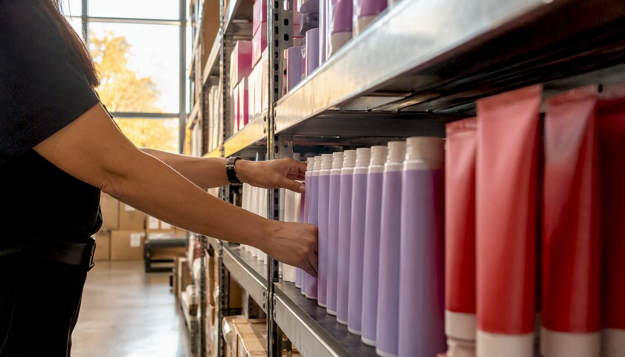 Shelves of professional salon haircare products in distributor warehouse