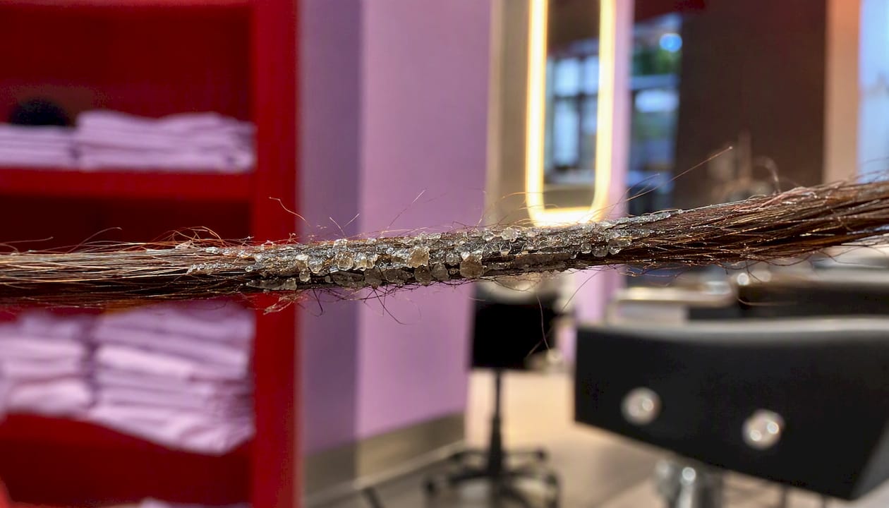 Close-up of hair strand with buildup
