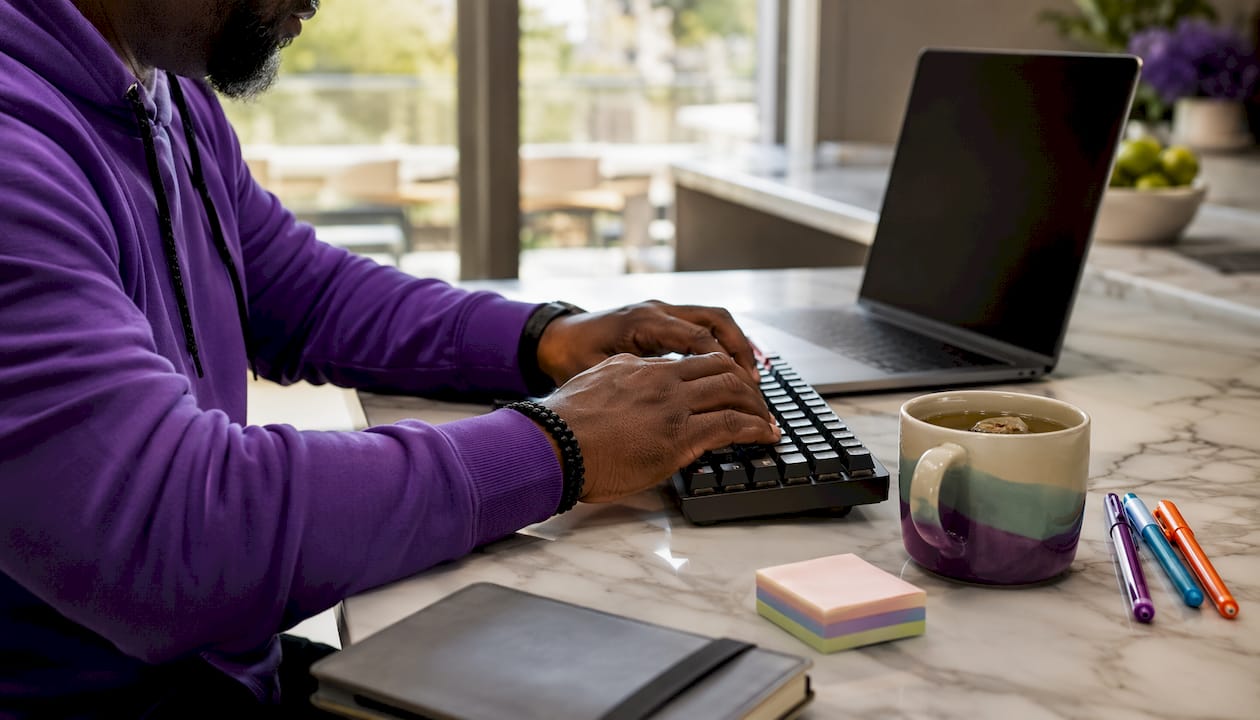 Hands typing in freelance content workflow home office