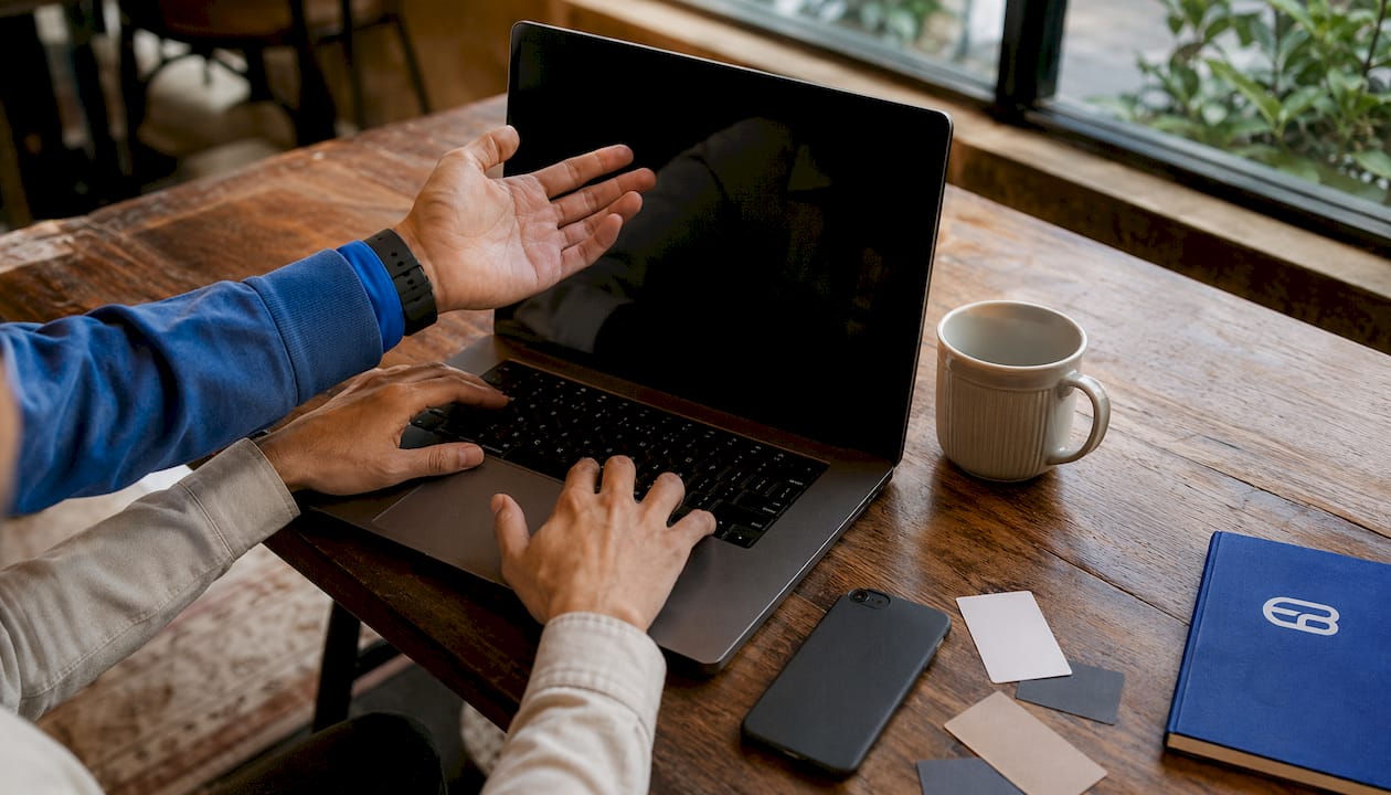Hands managing scheduling on laptop