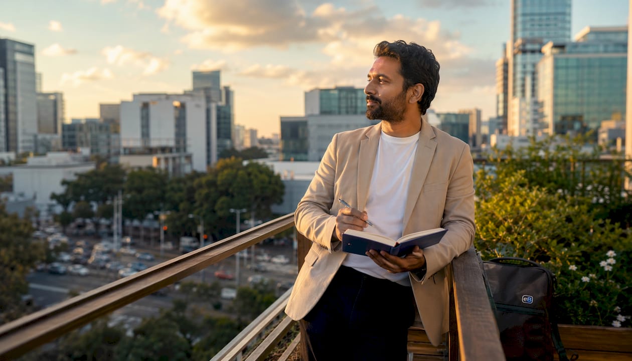Man reflecting on service sales mindset outdoors
