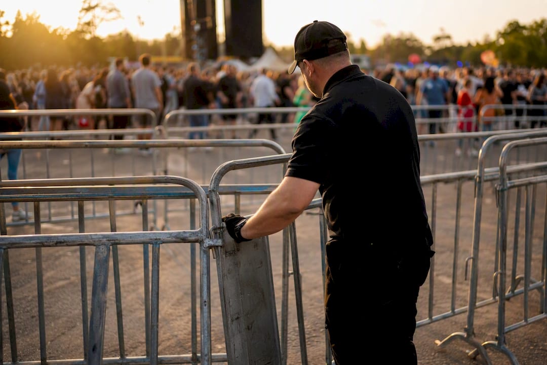 Festival security planning: the complete organiser's playbook 8 Security staff adjusting festival crowd barriers