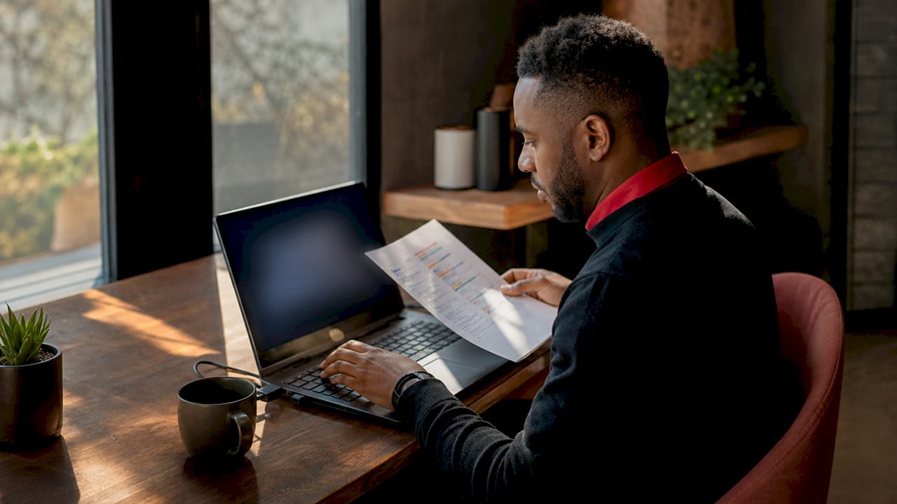IT manager using fingerprint scanner during compliance check