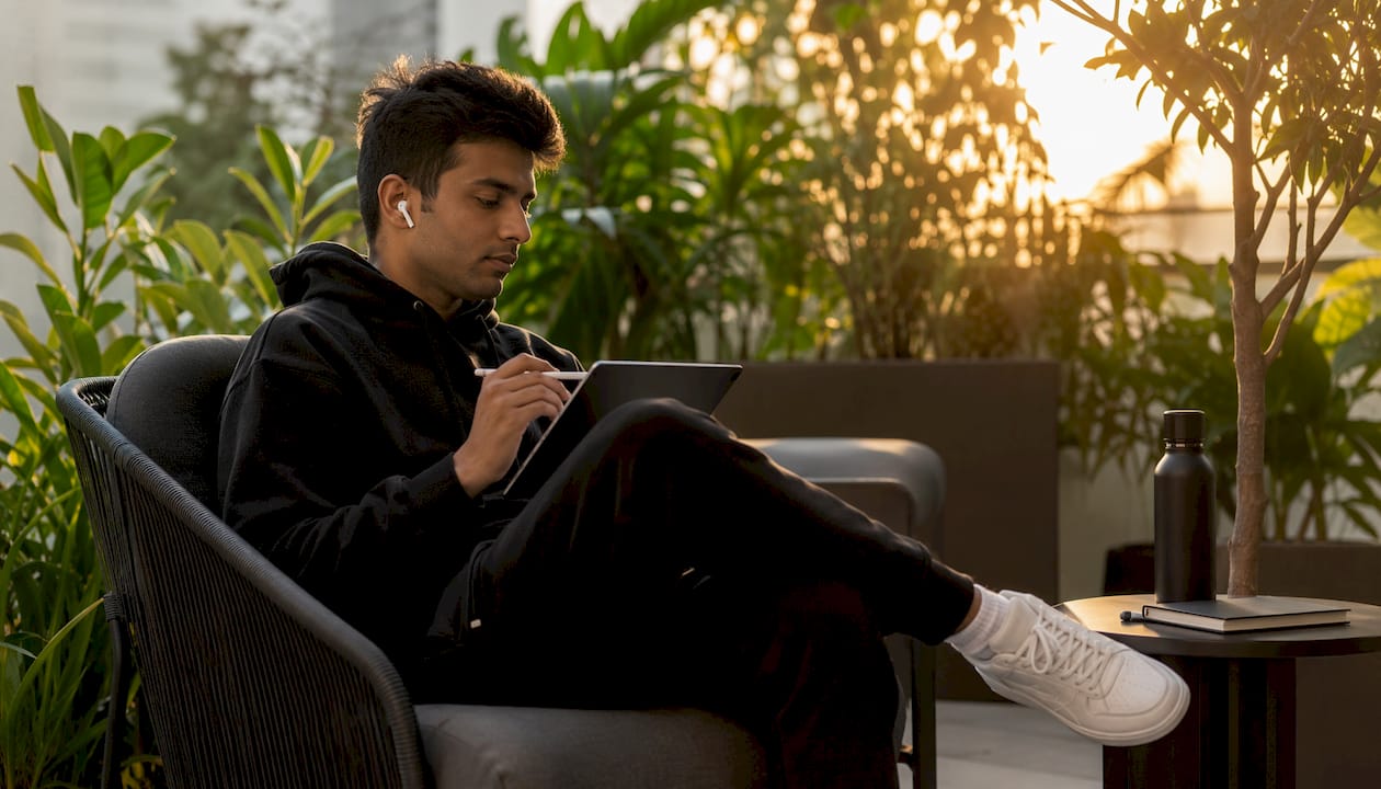 Person using tablet outdoors engaging with language voice technology