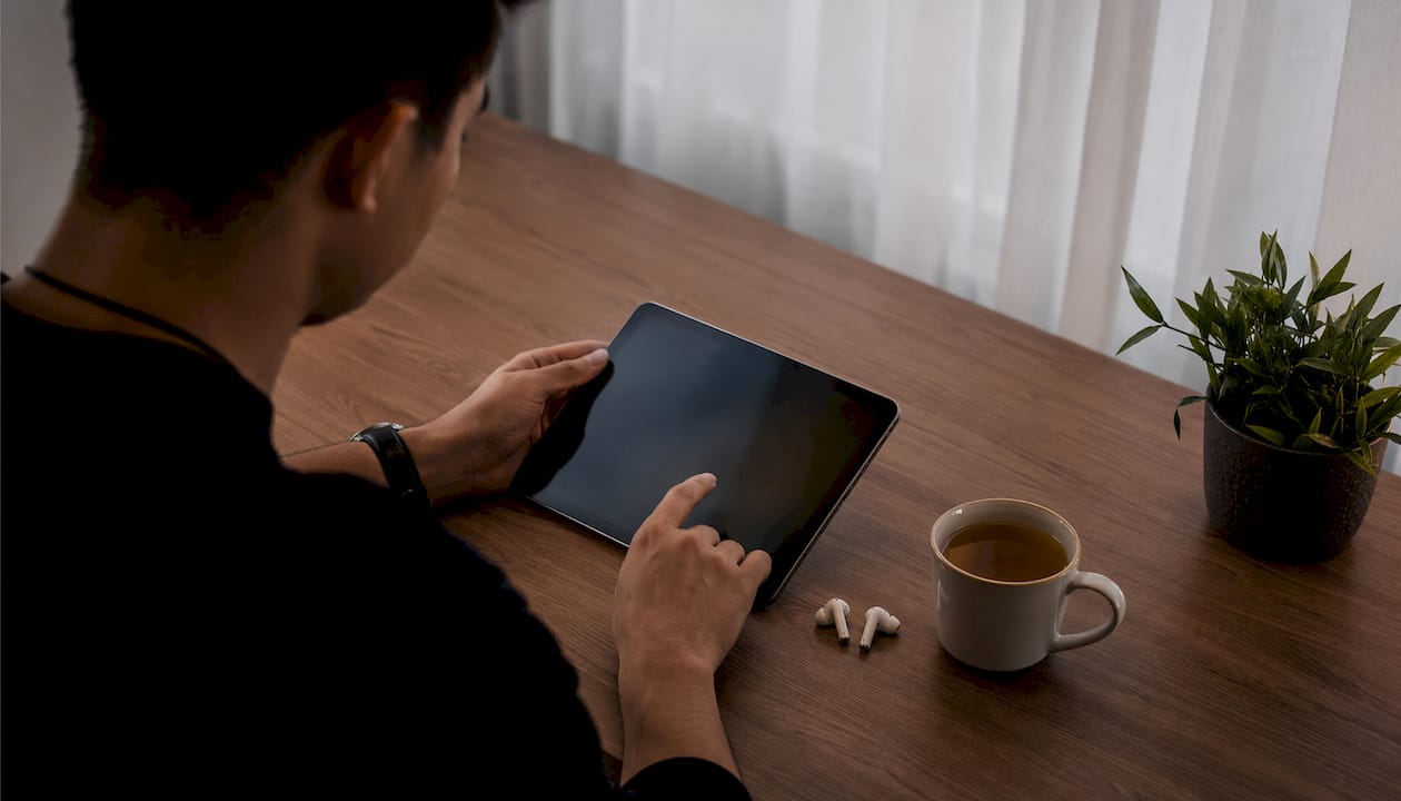 Hands interacting with audiobook app on tablet