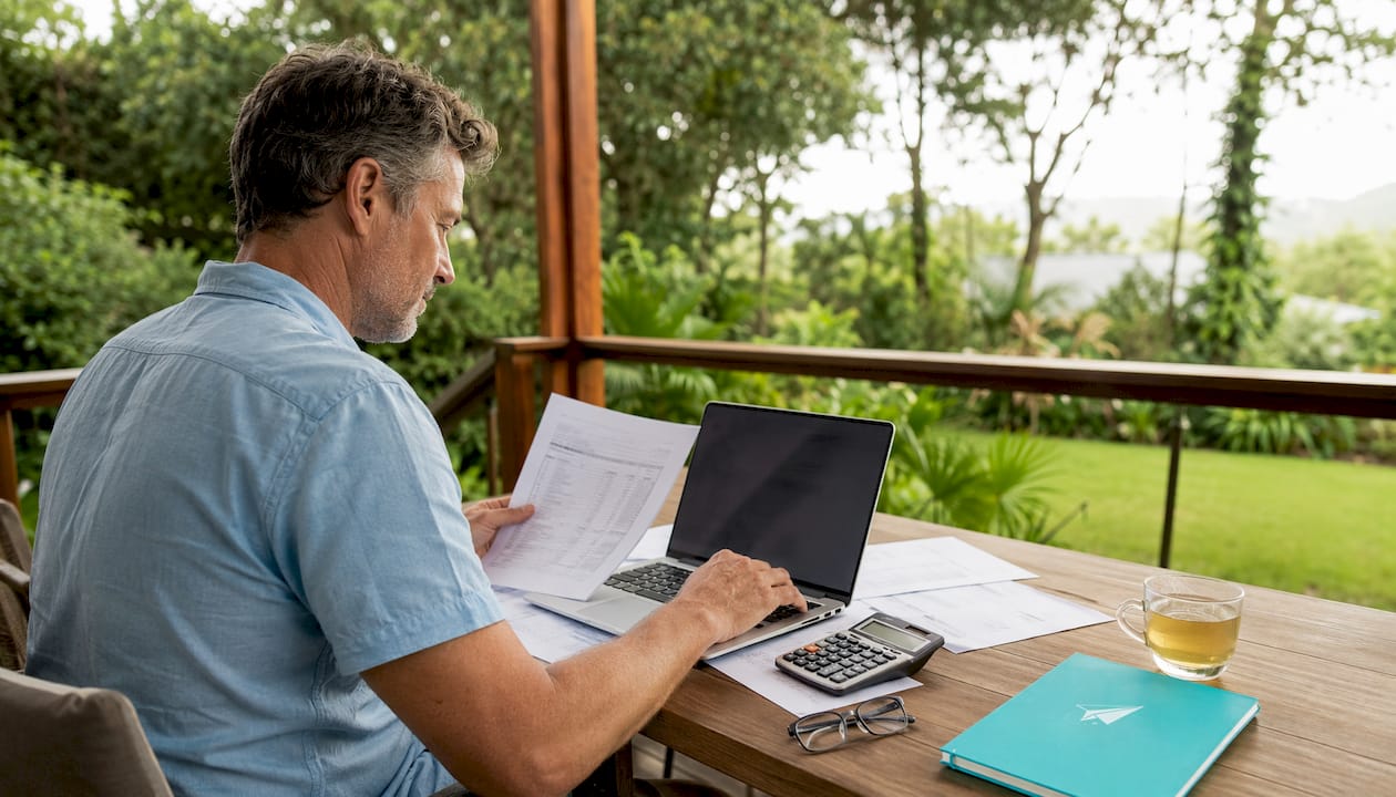 Man using mortgage Excel calculator at home
