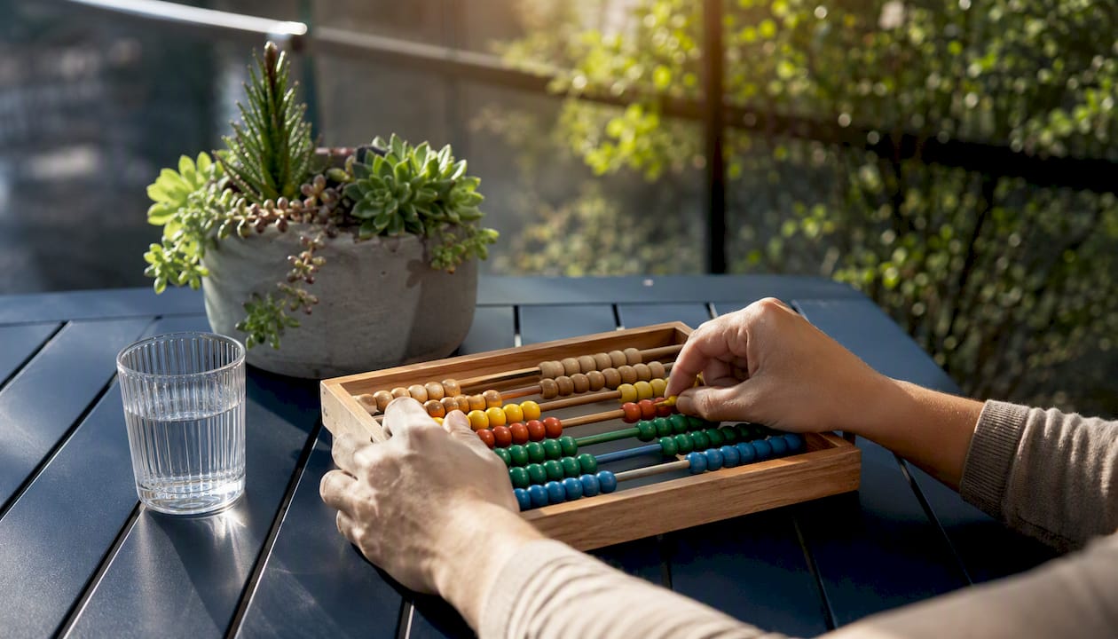 Hands moving abacus beads during financial review