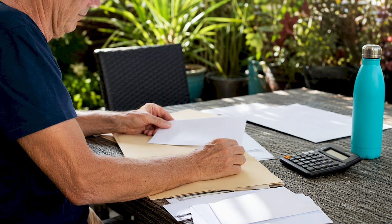 Hands sorting blank envelopes for super access