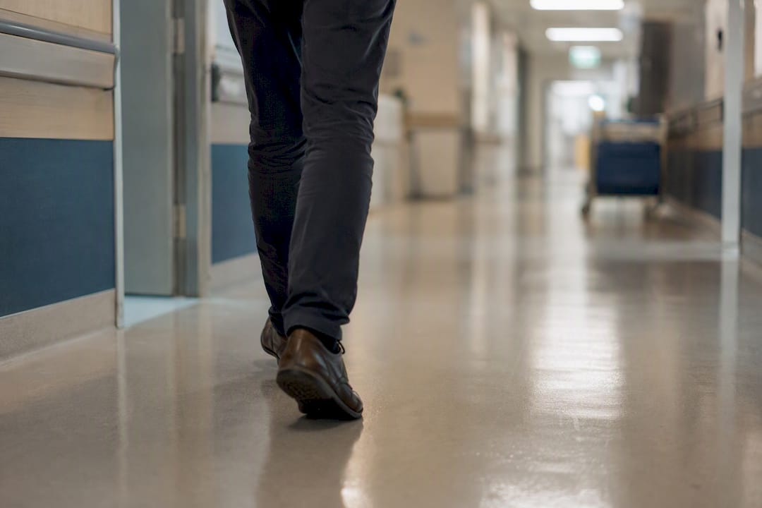 Patient walking through a hospital corridor