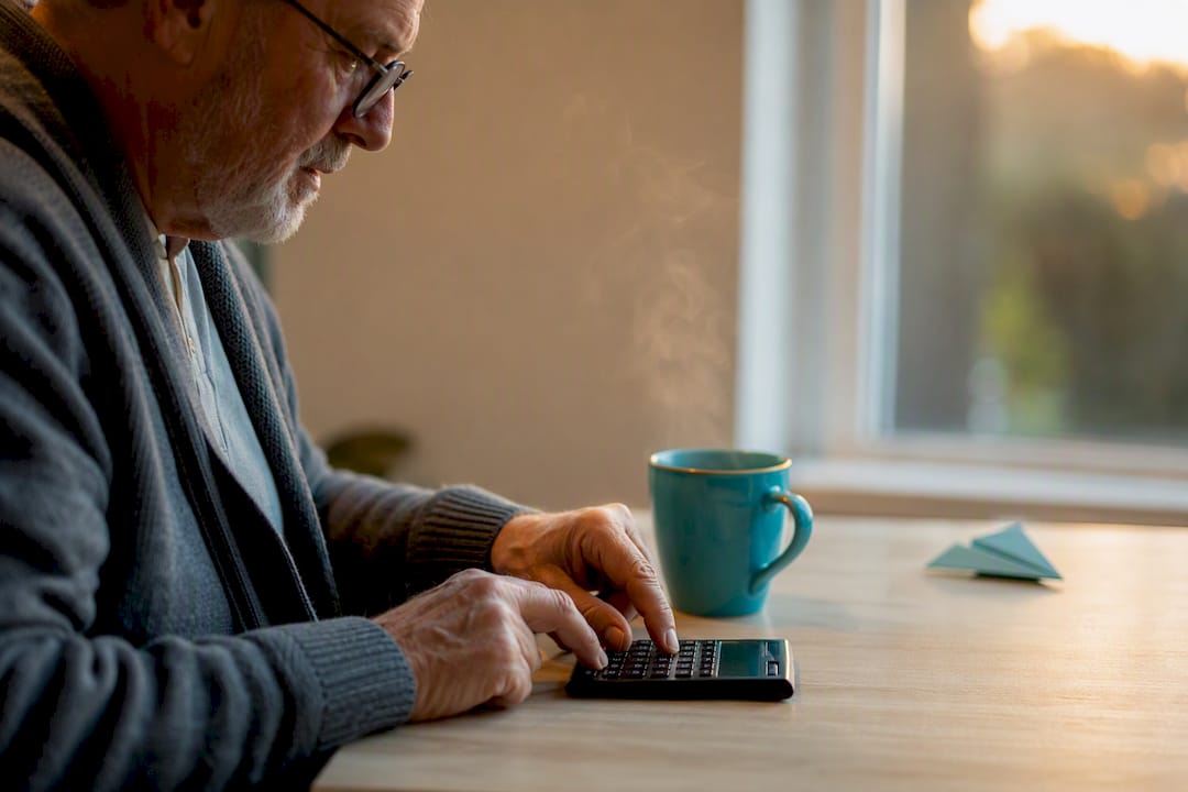 Hands calculating retirement budget