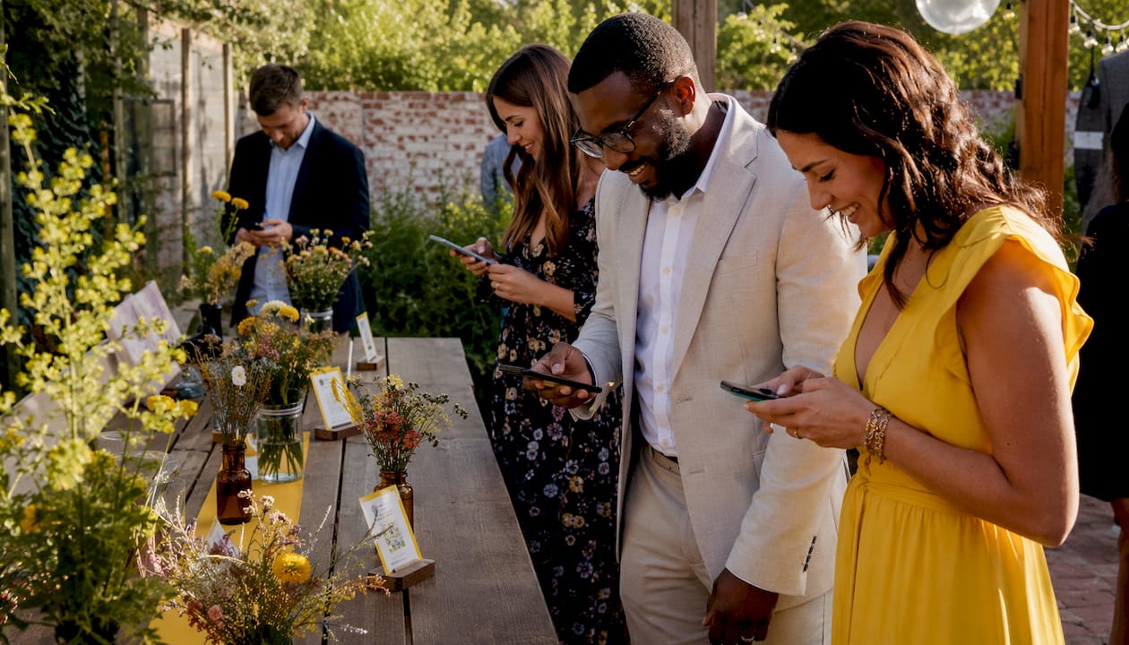 Guests scanning wedding QR codes with phones