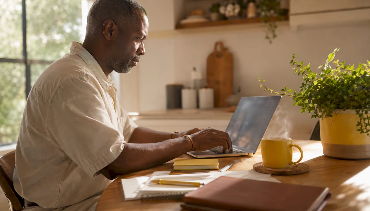 Host preparing RSVP and photo website at home desk