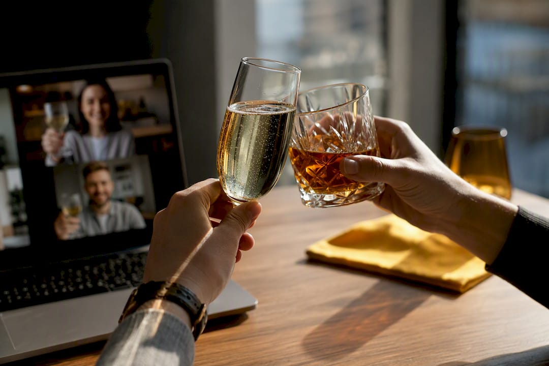 Remote guests raising drinks for virtual toast