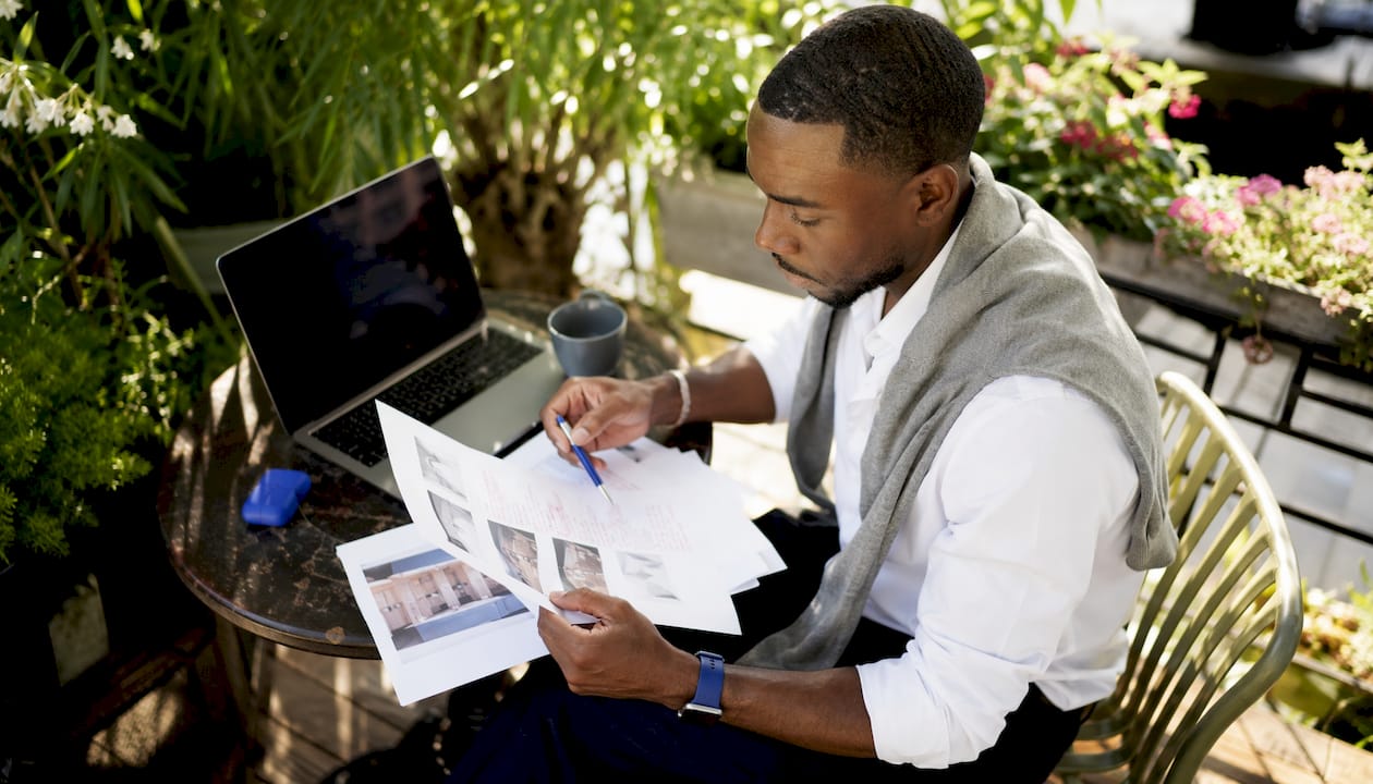 Man reviewing printed SEO content at standing desk