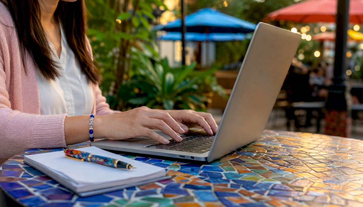 Hands typing competitor check on laptop