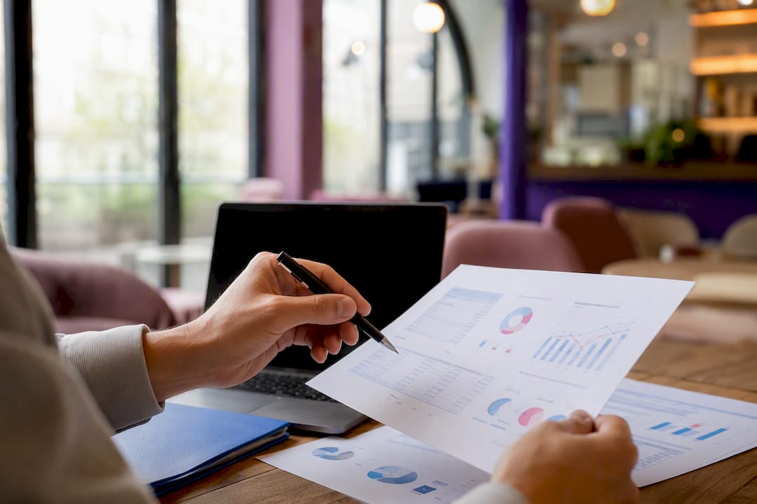 Hands pointing to charts in SEO data analysis