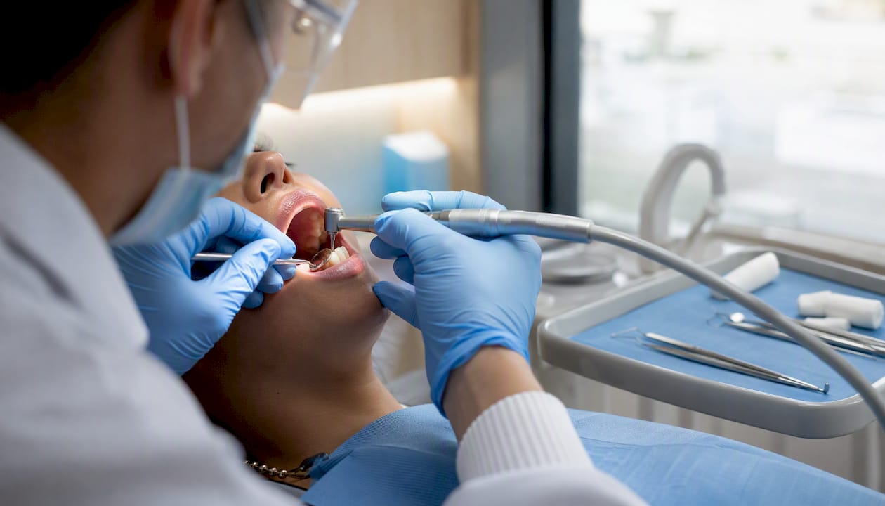Dentist preparing tooth for dental crown