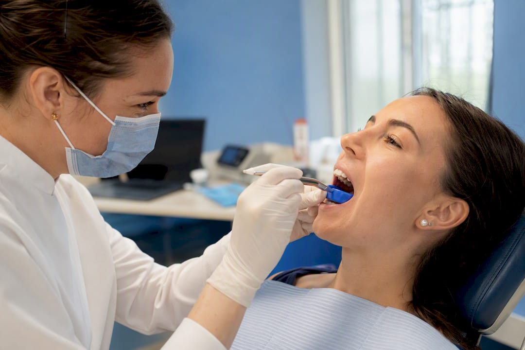 Dentist fitting custom mouthguard