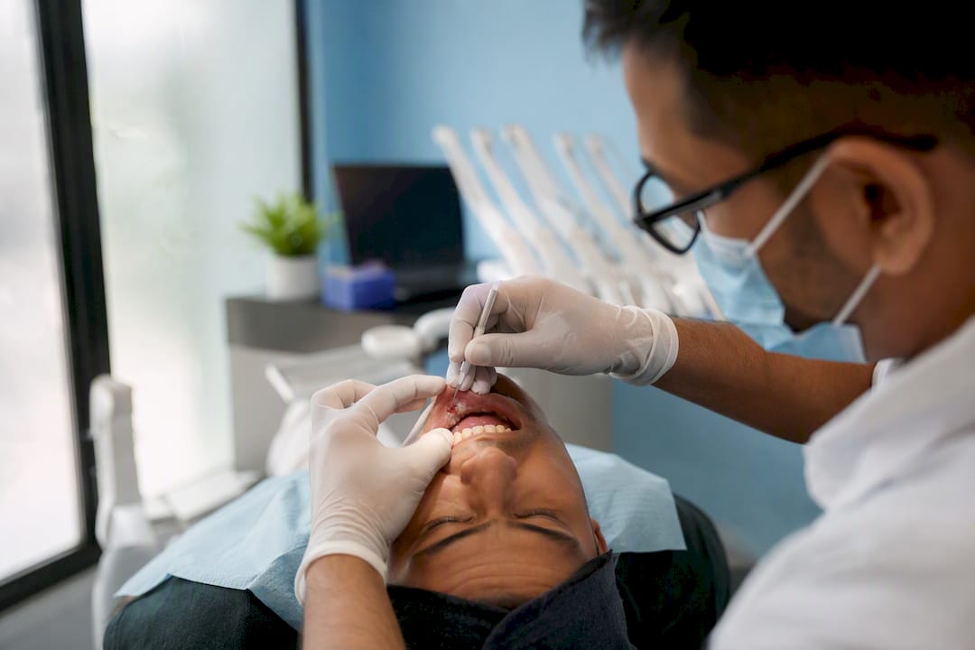 Dentist performing gum incision drainage