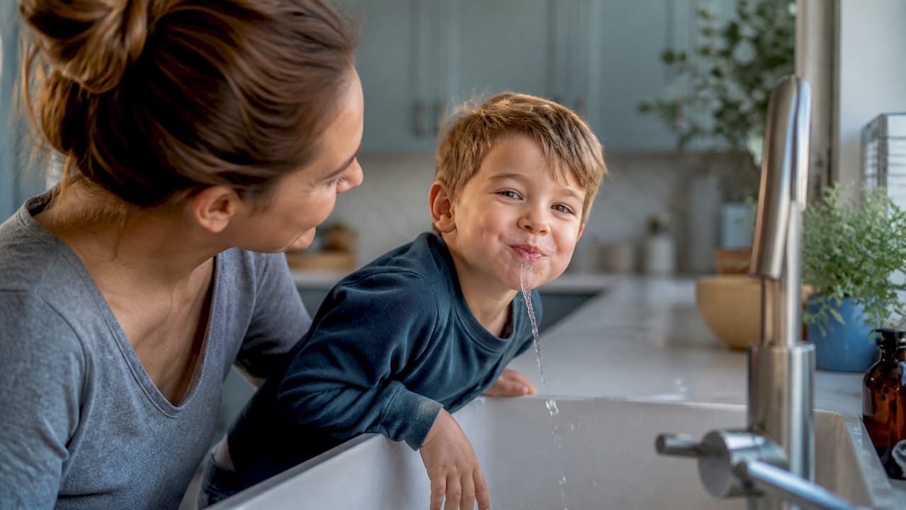 Child brushing teeth at home in morning