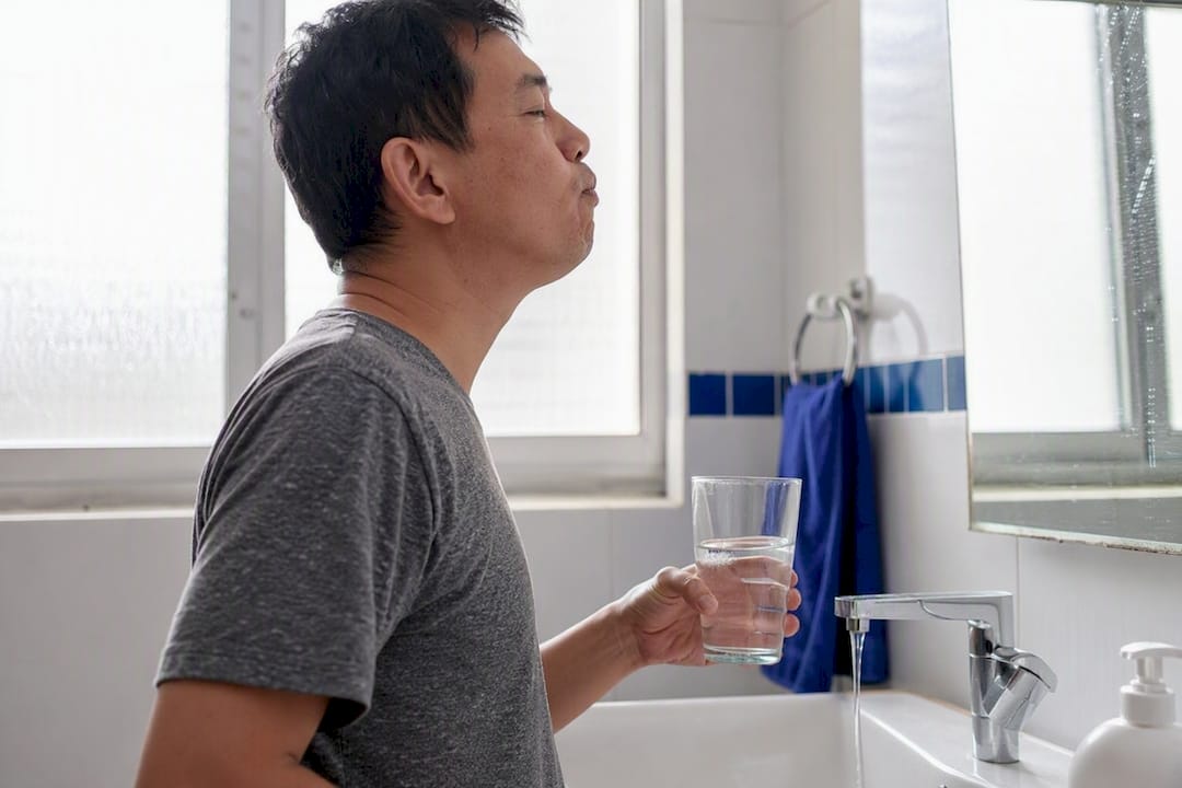 Person rinsing mouth with salt water