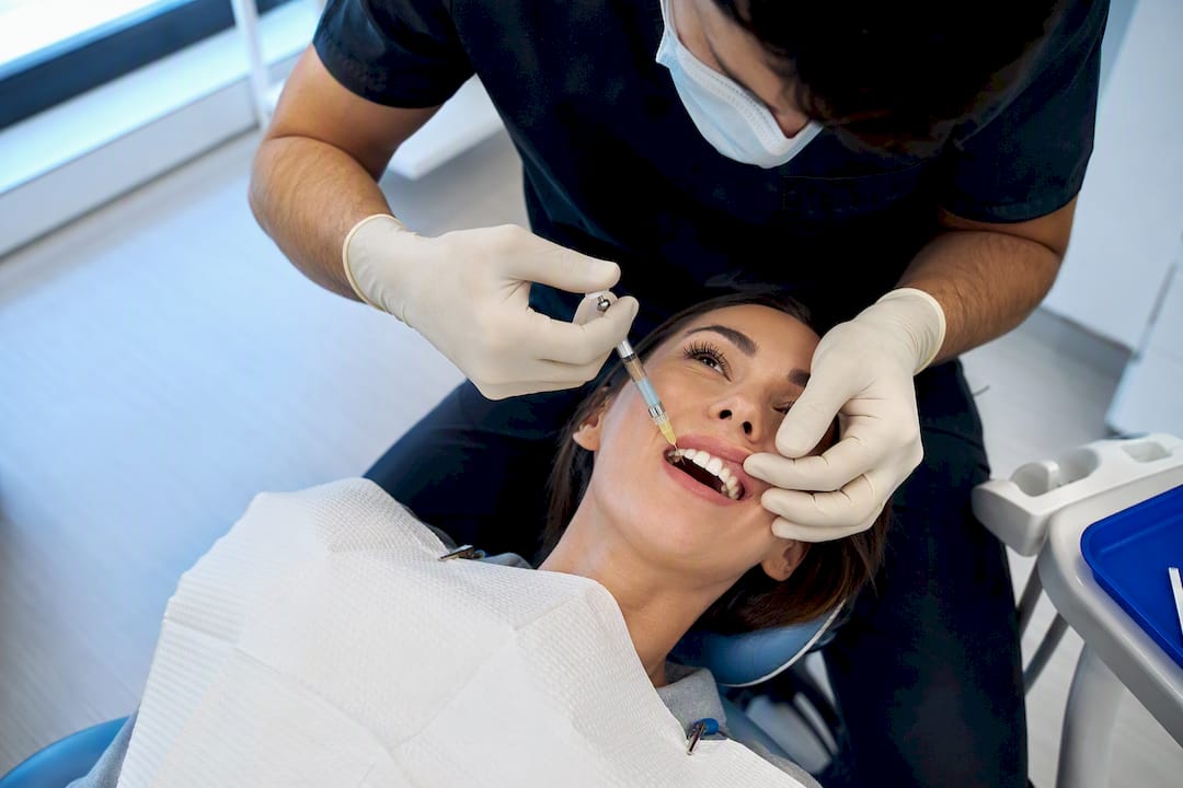 Dentist giving local anesthetic before filling