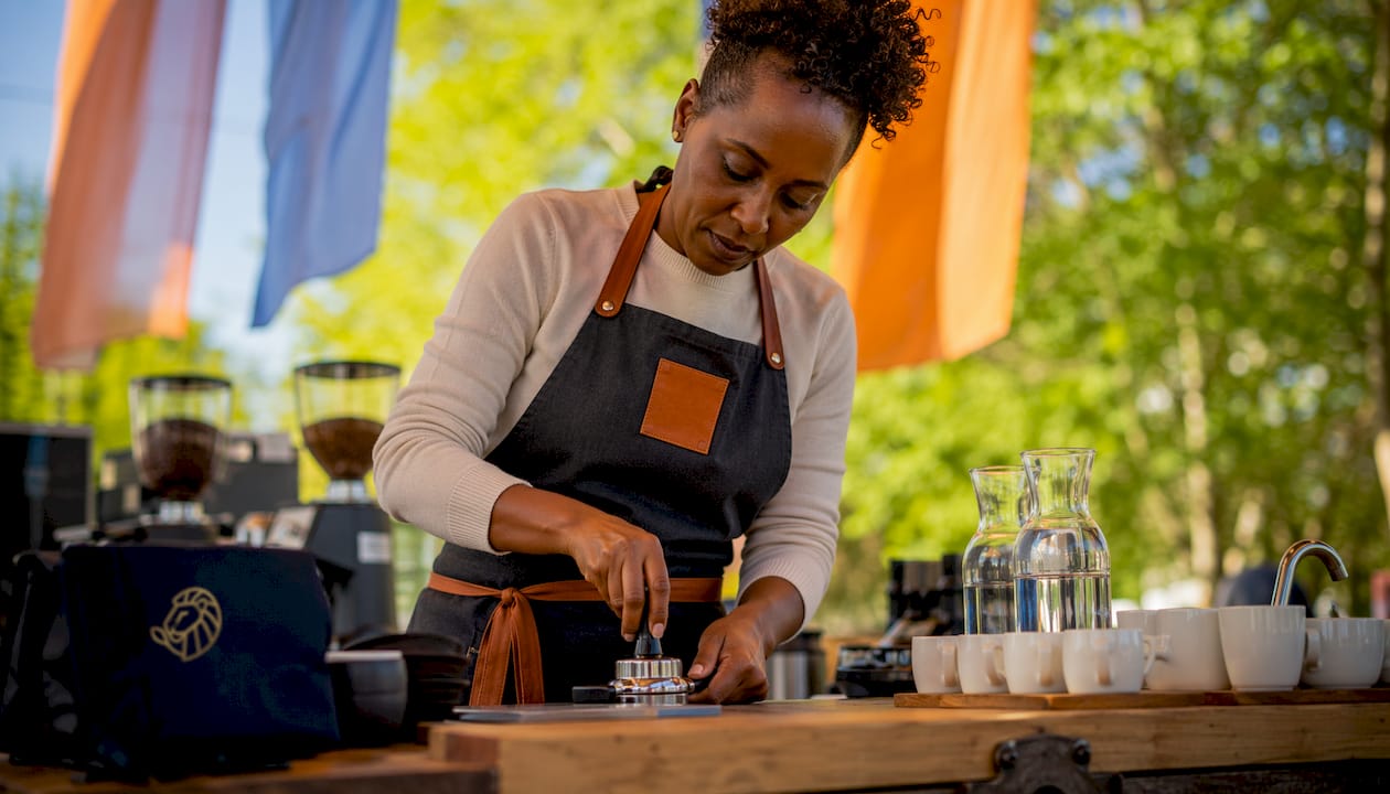 Barista tamping coffee at championship stage