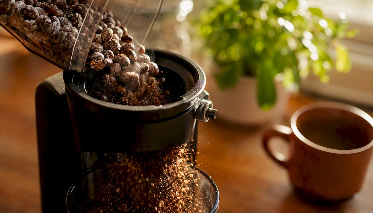 Grinding frozen coffee beans close-up