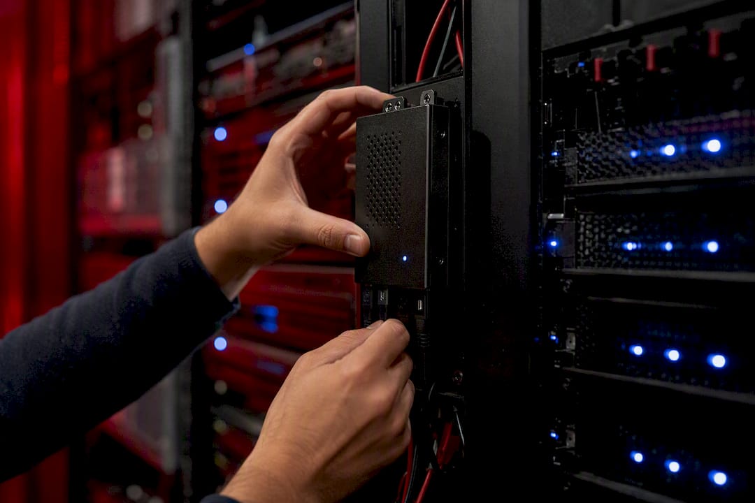 Hands adjusting security device on server rack