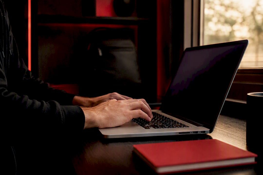 Hands editing server config on laptop keyboard