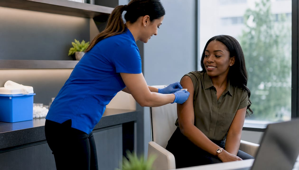 Healthcare provider giving flu shot to employee