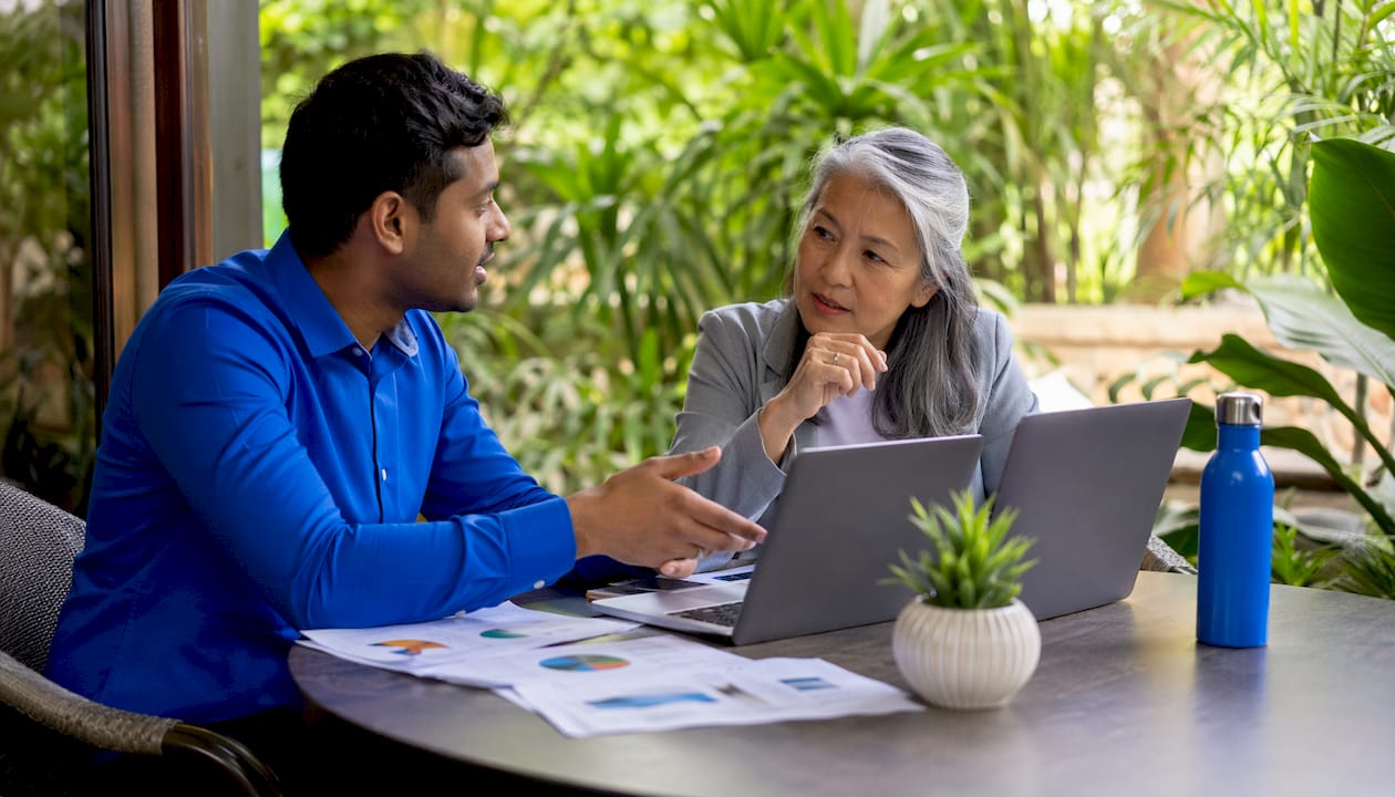 Two employees discussing inclusive wellness challenges