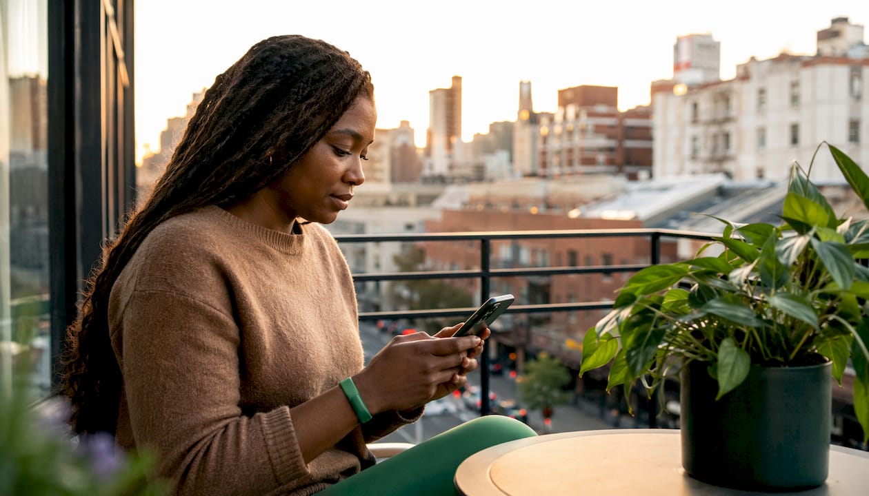 Woman using smartphone to track steps