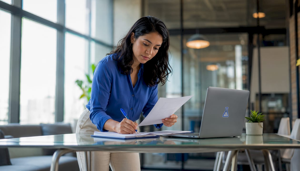 Woman reviewing invoice at home office desk
