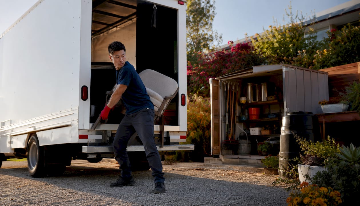 Licensed junk removal truck with driver preparing