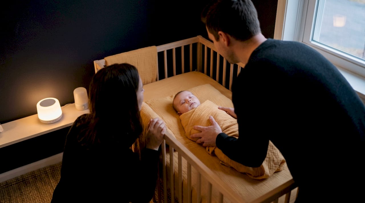 Parent calmly placing baby down before sleep