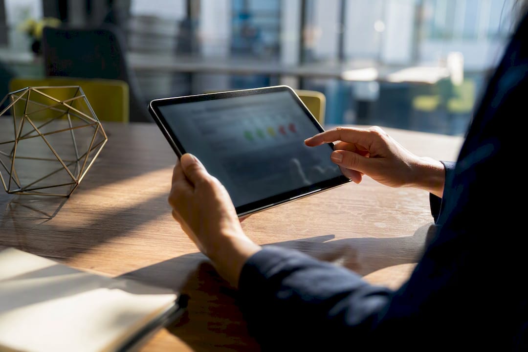 Franchisee hands tapping satisfaction survey on tablet