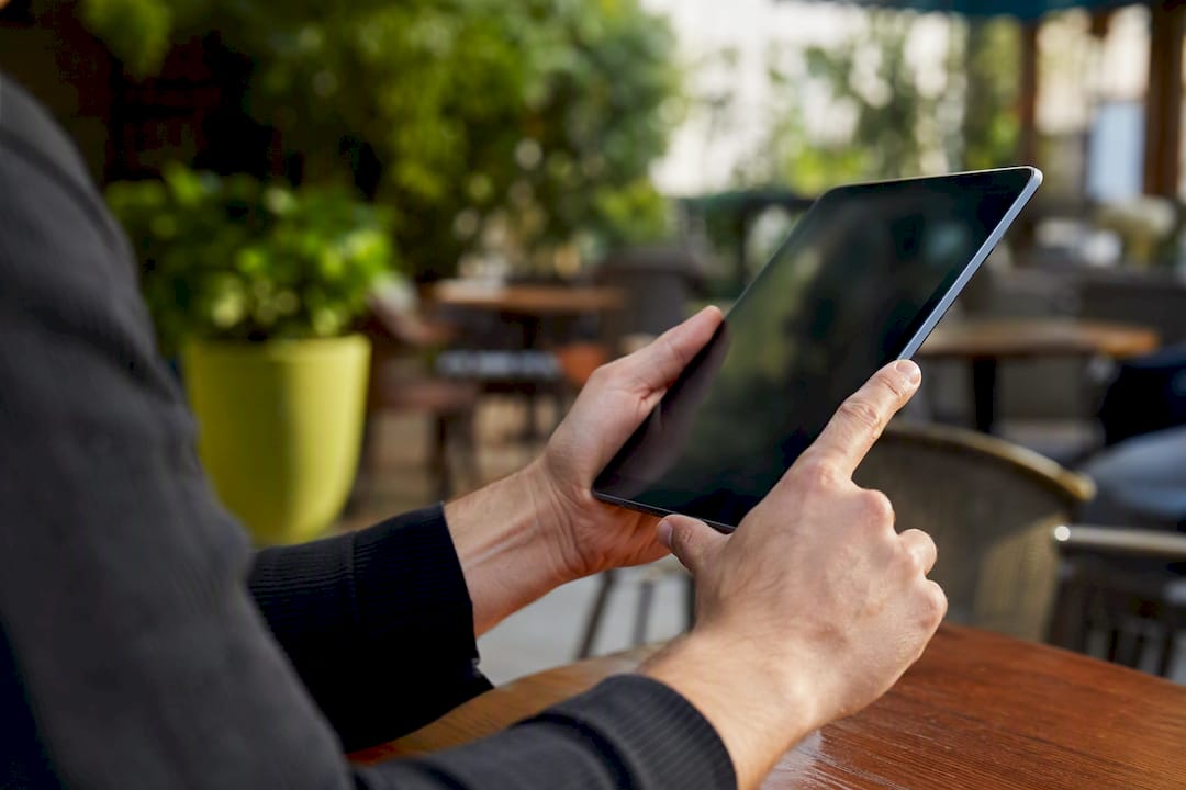 Hands holding a tablet in franchise office
