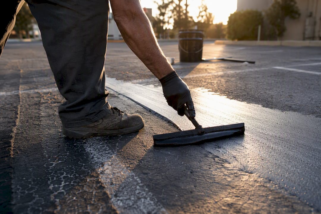 Close-up of sealcoat squeegee applying thin coat