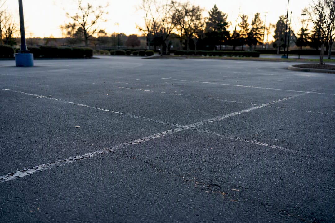 Faded parking lot lines on asphalt surface