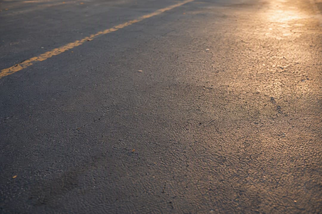 Close-up of aging asphalt with hairline cracks