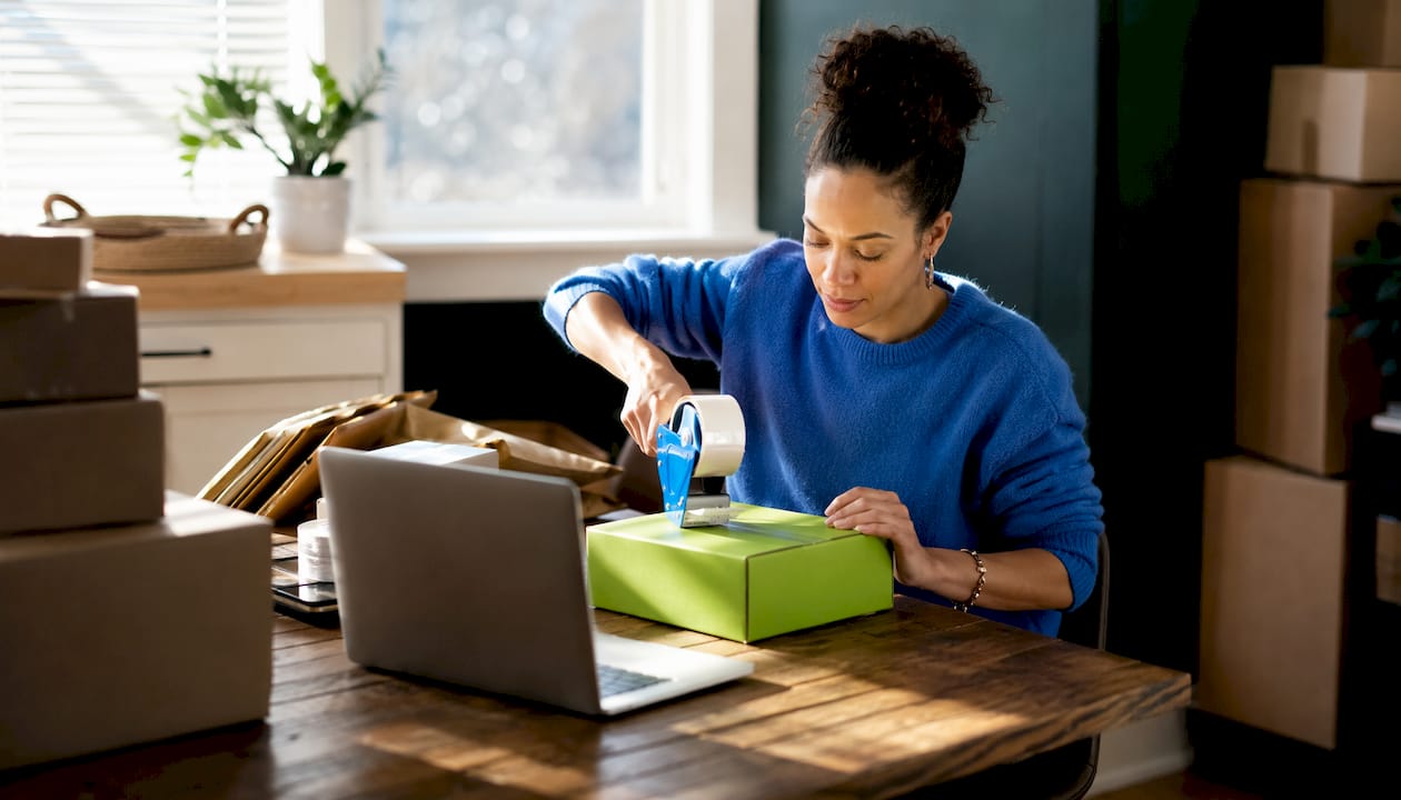 Entrepreneur packing ecommerce orders at home