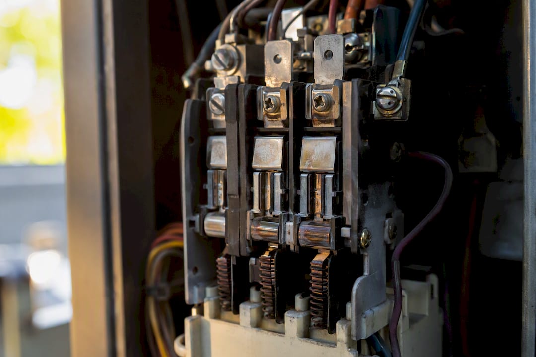 Close-up of AC unit contactor relay showing wear