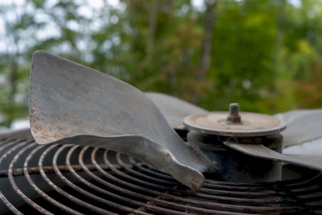 Bent AC fan blade indicating imbalance