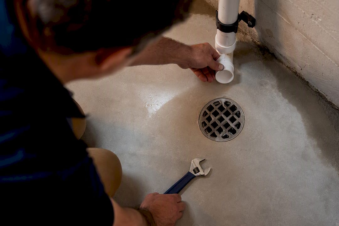 Installer checking basement condensate drain