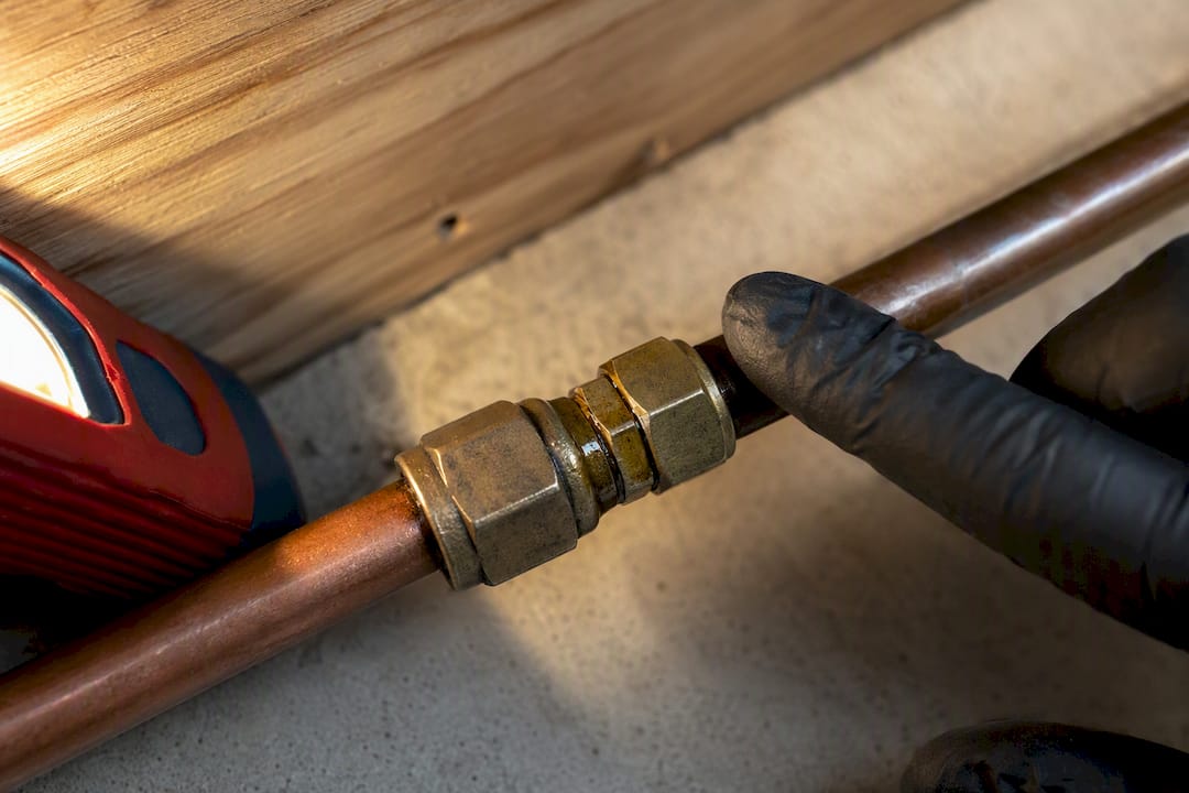 Oily residue around a refrigerant line fitting