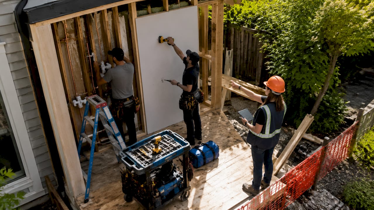Female contractor coordinating subcontractors on site