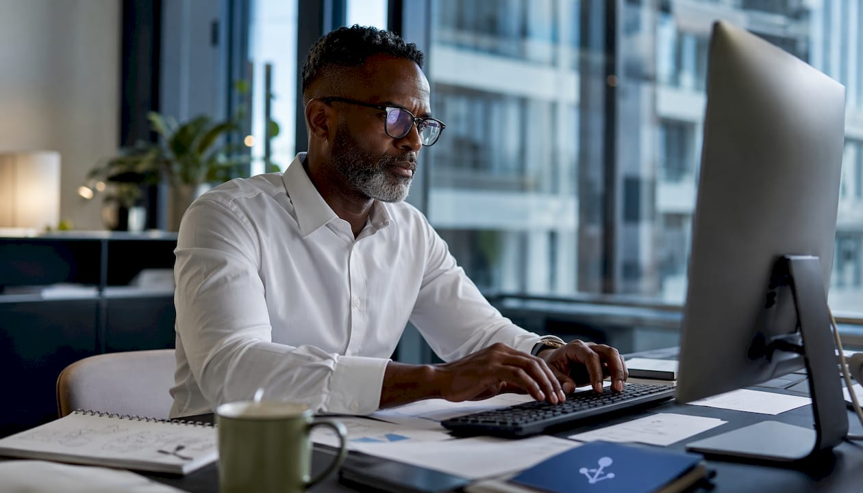 Man reviewing AI operational data at desk